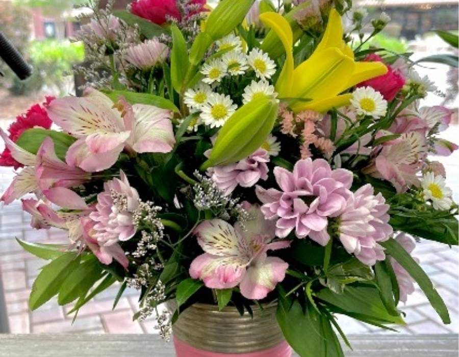Vibrant bouquet featuring pink alstroemeria, yellow lilies, white daisies, and assorted greenery in a decorative floral arrangement from Berkeley Flowers & Gifts.