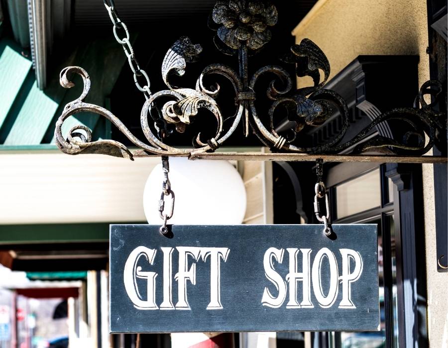 Vintage-style wrought iron sign reading “Gift Shop” hanging outside a charming storefront in Bluffton, South Carolina.
